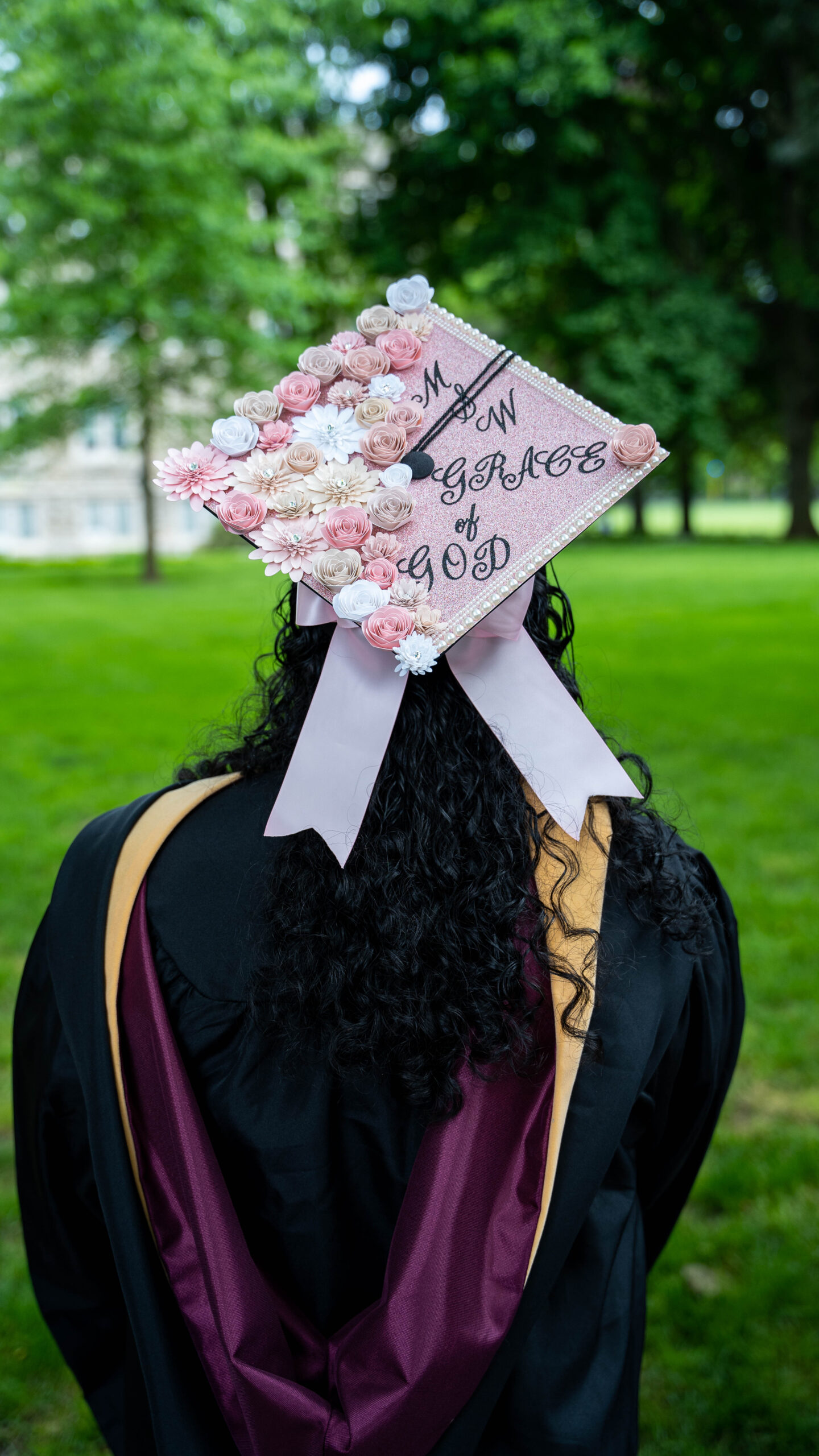 grad cap that reads "msw grace and God" with pink flowers