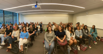 A panoramic photo of students sitting in a classroom for our westchester campus orientation.