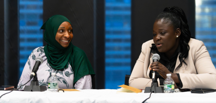 panelist Marthe Kiemde (right) speaks whiile co-panelist Adama Bah (left) watches on and smiles.