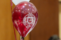 a maroon balloon with the fordham seal in white on it.