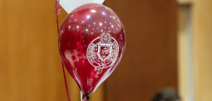 a maroon balloon with the fordham seal in white on it.