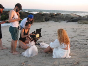 the crew films a scene at the beach