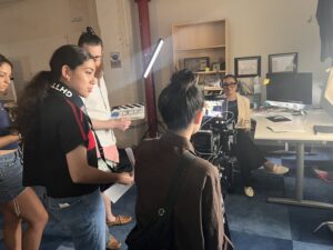 director maya velazguez watches on as a scene is shot