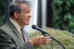 George Latimer speaks at the podium at the Fordham Westchester Campus.