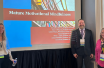 (left to right) JoAnne McMahon, Henry Davis, and Laura Sutter pose in front of their presentation at the conference