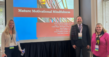 (left to right) JoAnne McMahon, Henry Davis, and Laura Sutter pose in front of their presentation at the conference