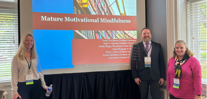 (left to right) JoAnne McMahon, Henry Davis, and Laura Sutter pose in front of their presentation at the conference