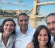 pam gawley poses with three others in front of London's tower bridge