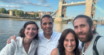 pam gawley poses with three others in front of London's tower bridge