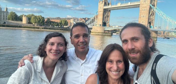 pam gawley poses with three others in front of London's tower bridge