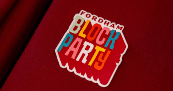 a sticker that says fordham block party on a maroon table