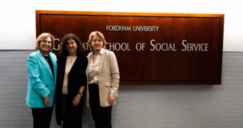 from left to right: Fordham GSS Associate Dean for Academic Affairs Dr. Linda White-Ryan, Lydia Sapouna, Fordham GSS Dean Dr. Debra M. McPhee - they all stand in front of a sign that reads "Fordham Graduate School of Social Service"